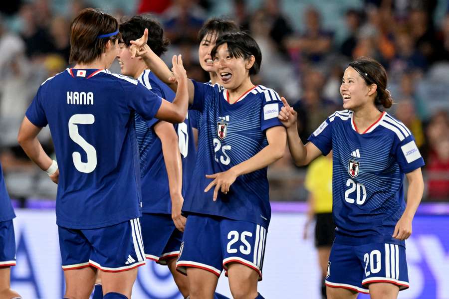 Japan's players celebrate a goal