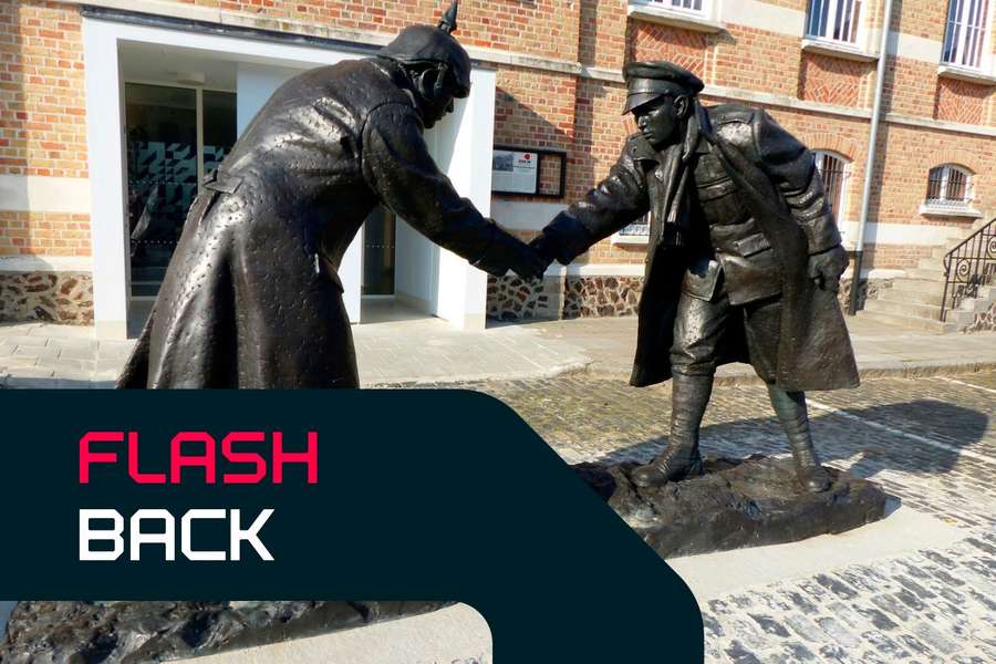 A statue of a German and a British soldier shaking hands over a football