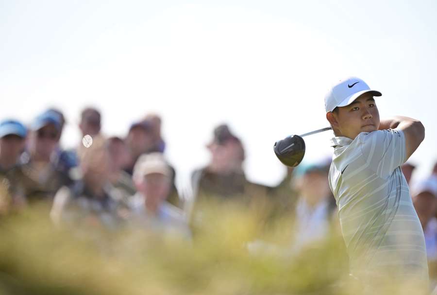 Tom Kim plays from the 15th tee on the opening day of the British Open Championship