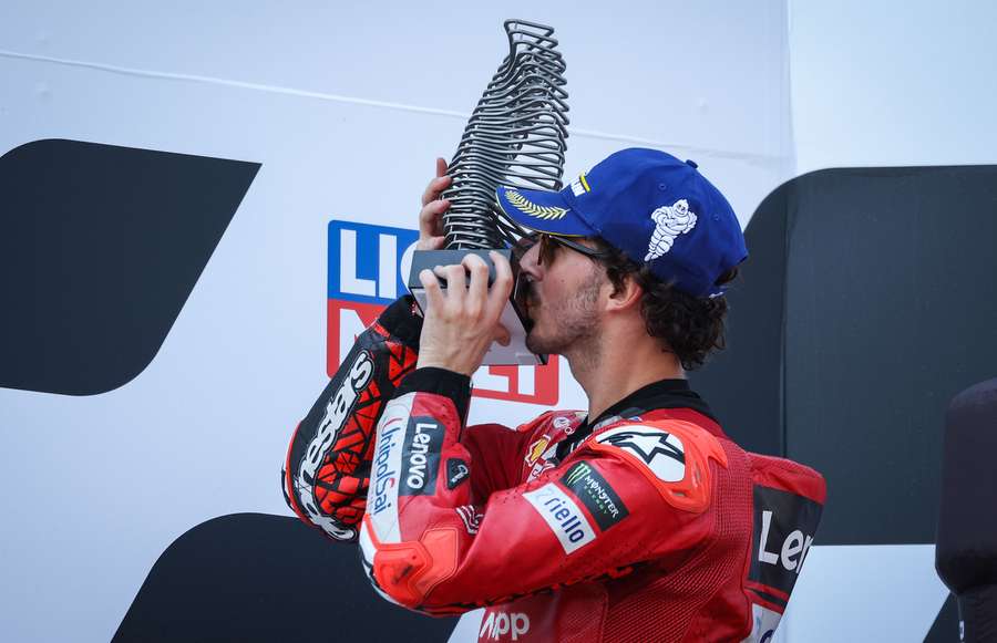 Second-placed Ducati Lenovo rider Francesco Bagnaia kisses his trophy