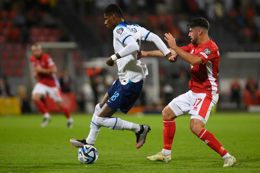 England forward Marcus Rashford (L) works around Malta midfielder Nikolai Muscat