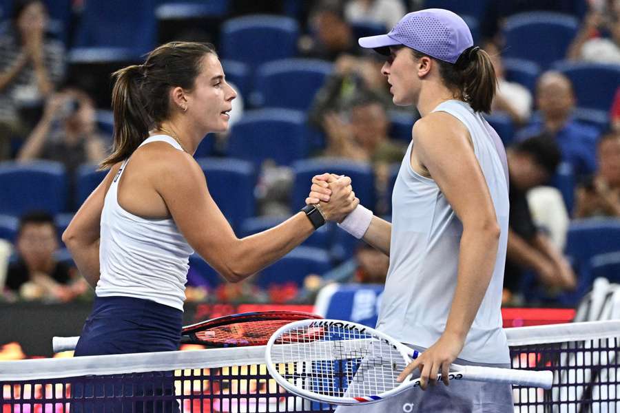 Emma Navarro (left) shakes hands with Iga Swiatek