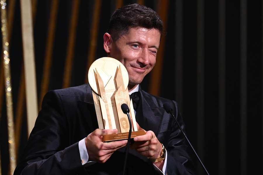 Robert Lewandowski receives the Gerd Muller Trophy for best striker during the 2022 Ballon d'Or France Football award ceremony