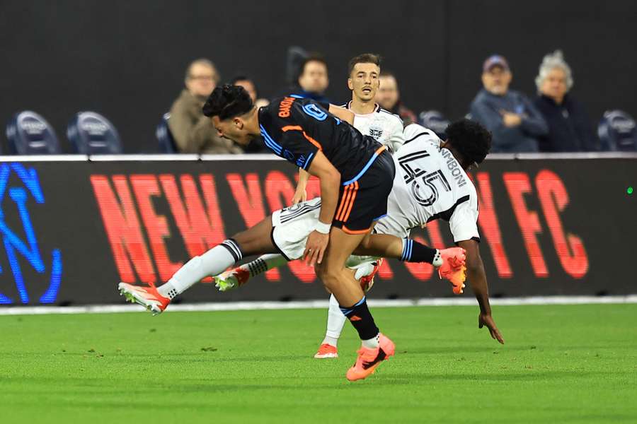 New York City FC forward Monsef Bakrar #9 is colliding with D.C. United FC defender Matai Akinmboni #45