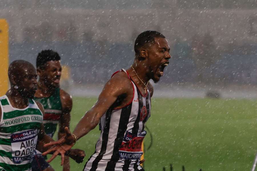 Hughes celebrates as he crosses the line