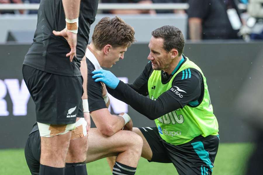 Beauden Barrett seeks medical assessment on his right shoulder during Saturday's win over Australia. 