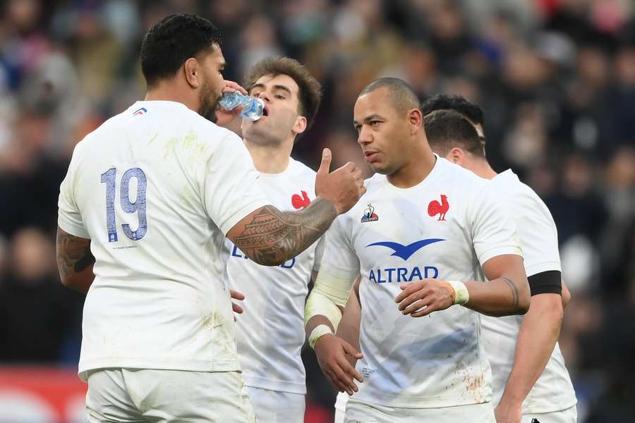 France's centre Gael Fickou celebrates with teammates after scoring a try