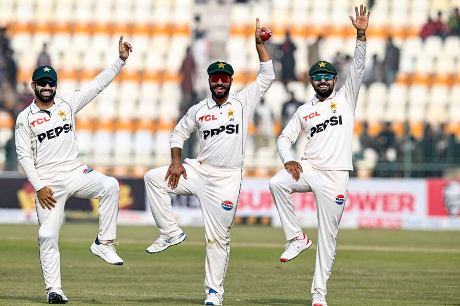 Pakistan's Sajid Khan (centre) celebrates with Mohammad Rizwan and Babar Azam after winning the first Test against West Indies 
