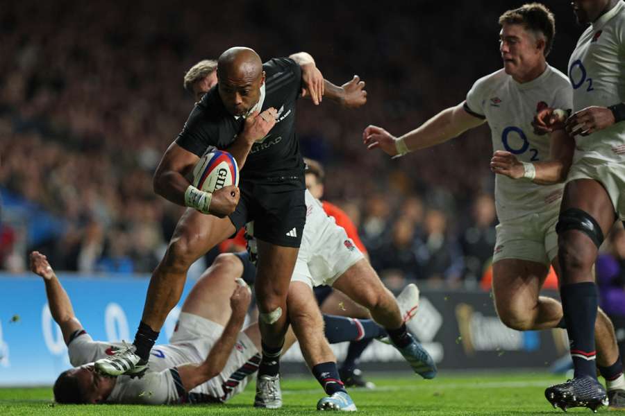 New Zealand's Mark Tele'a fights his way to the try line during the Autumn Nations Series International against England