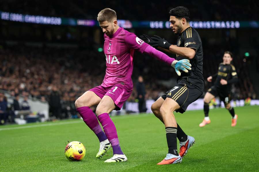 Guglielmo Vicario is challenged by Raul Jimenez prior to Fulham scoring their second goal inside the opening six minutes