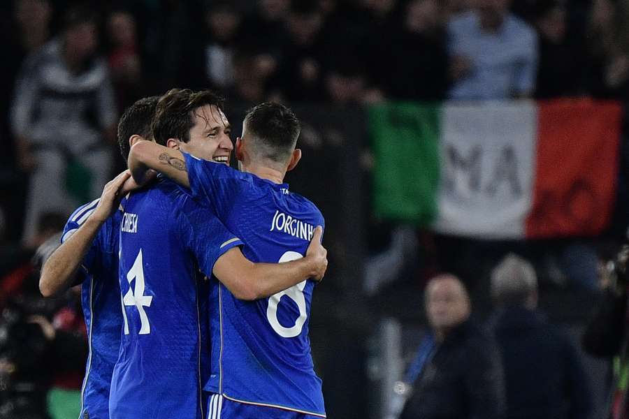 Italy's forward #14 Federico Chiesa celebrates with teammates after scoring the team's third goal 