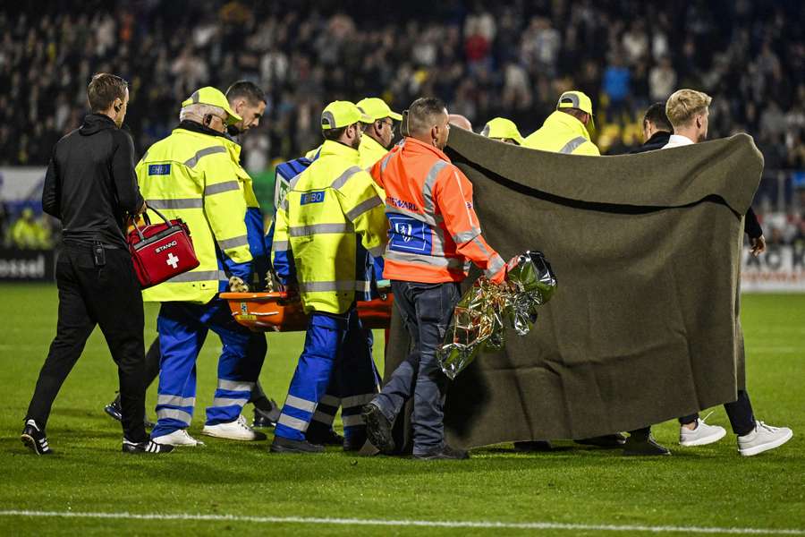 Goalkeeper Etienne Vaessen is taken off the pitch