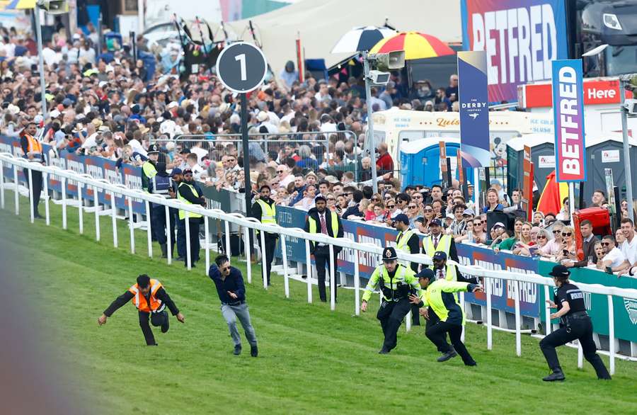 An Animal Rising protester enters the racecourse at Epsom