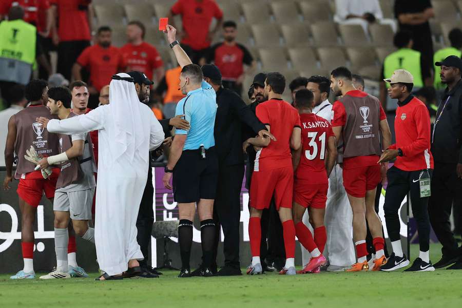 Referee Shaun Evans shows a red card to Hamad Al Meqebaali at the end of the contest

