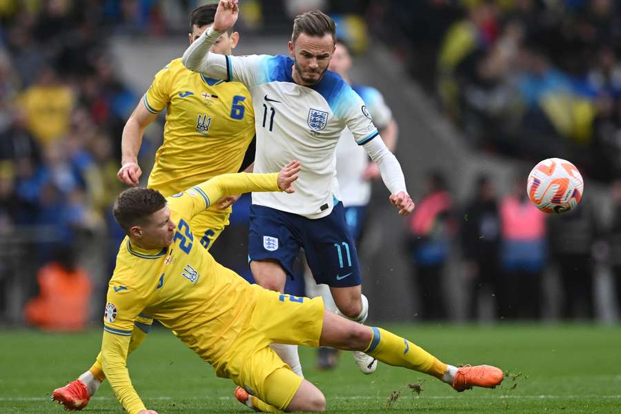 Ukraine's defender Mykola Matviyenko tackles England's midfielder James Maddison