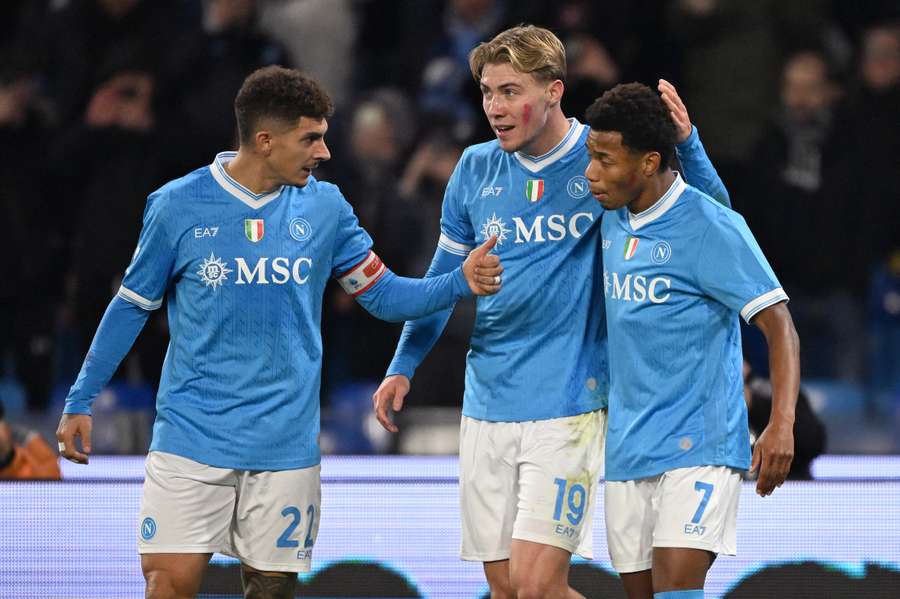 Napoli's Giovanni Di Lorenzo, left, and Rasmus Hojlund, centre, celebrate David Neres' opener