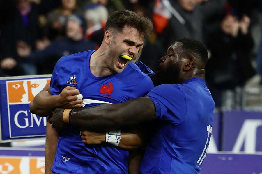 France's Damian Penaud celebrates scoring their second try with teammates