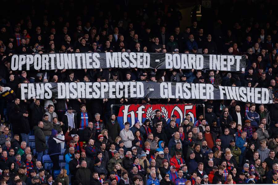 Crystal Palace's fans protest against manager Oliver Glasner before the game with Wolves