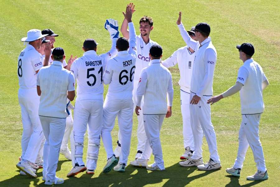 England's Josh Tongue celebrates with teammates after taking his first test wicket