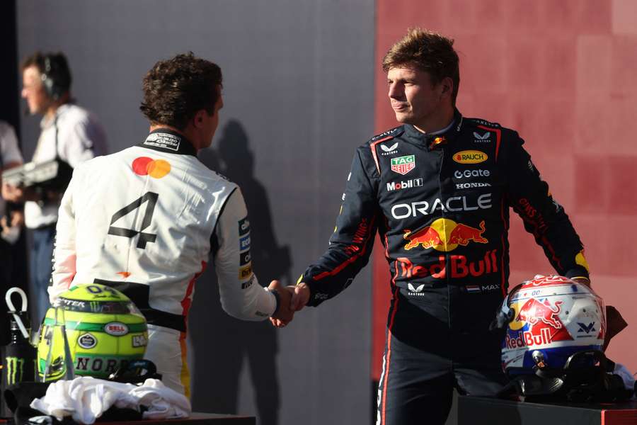 Max Verstappen (right) shakes hands with Lando Norris (left) after qualifying in pole position (2025)