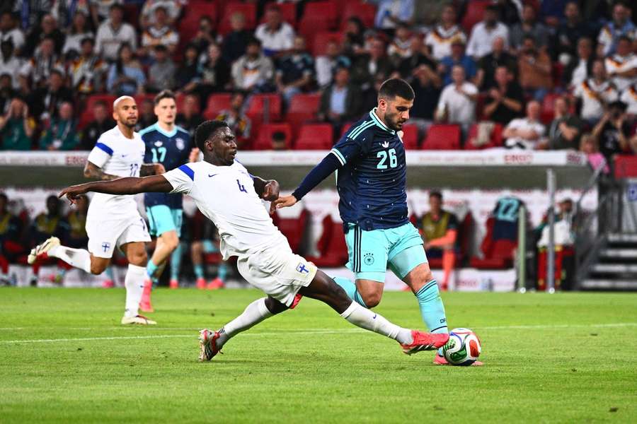 Deniz Undav (right) beats Tony Miettinen to the ball en route to scoring