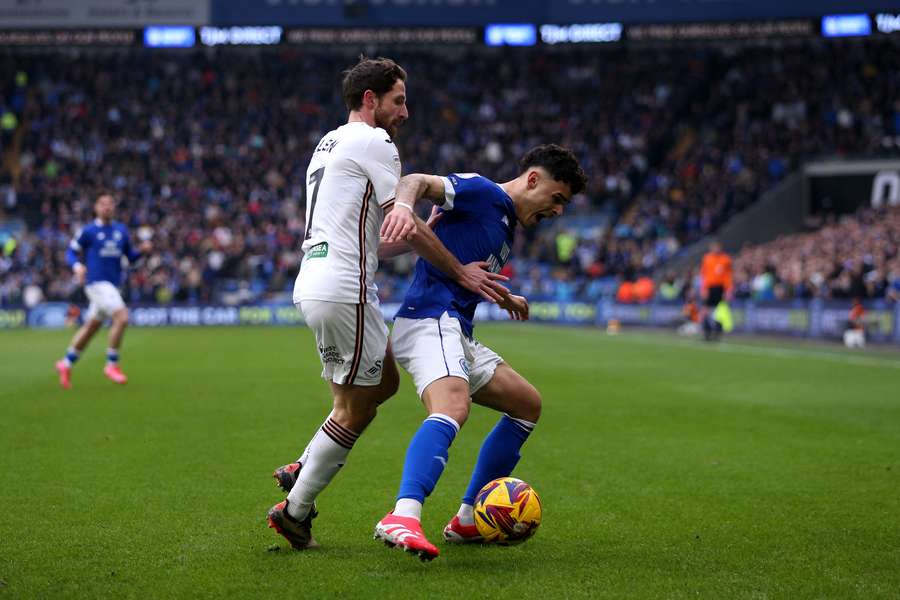 Alex Robertson battles with Joe Allen of Swansea City last season.