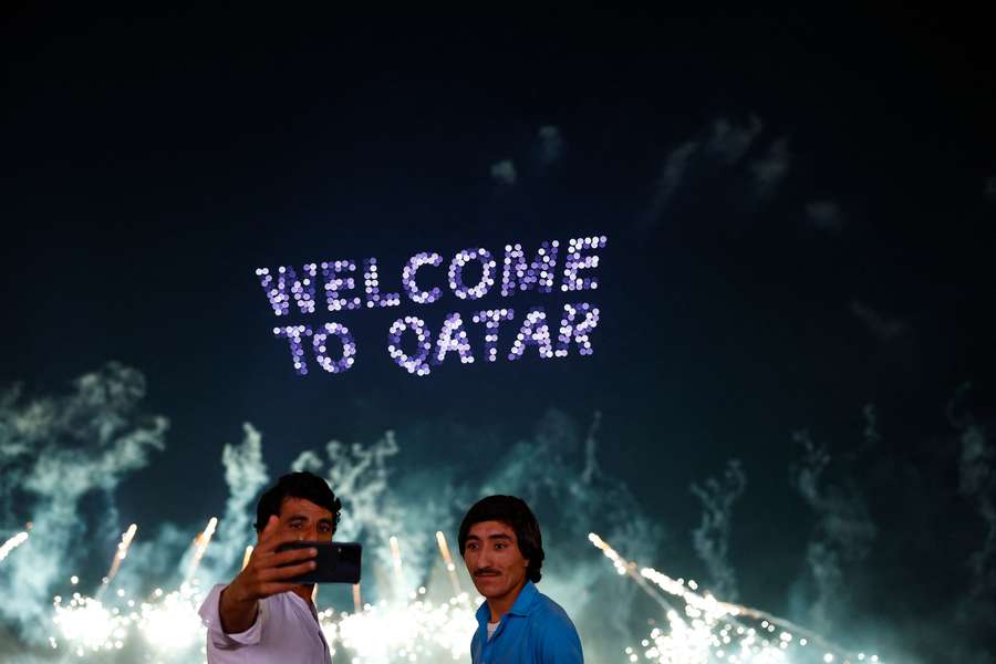 People take a selfie during the fireworks display at the World Cup