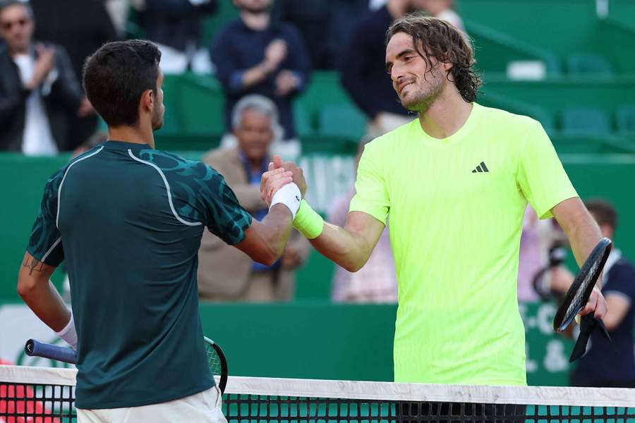 Lorenzo Musetti (L) meets Stefanos Tsitsipas (R) at the net