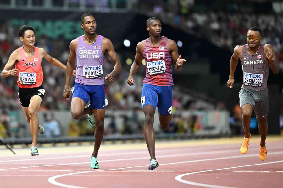 USA's Erriyon Knighton crosses the finish line ahead of Zharnel Hughes in the men's 200m semi-final