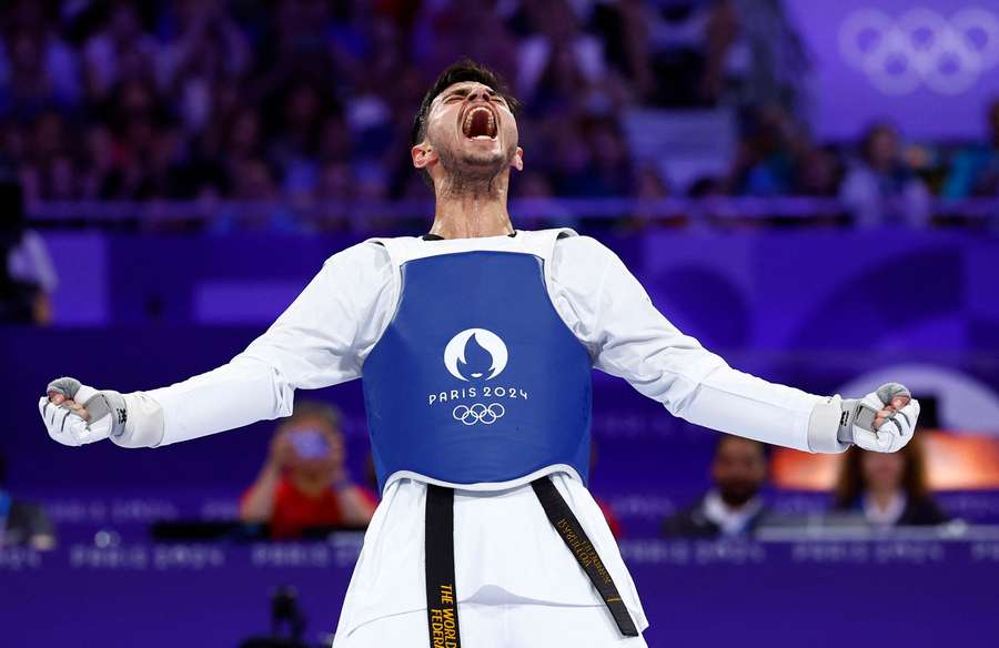 Ulugbek Rashitov of Uzbekistan celebrates winning the gold medal