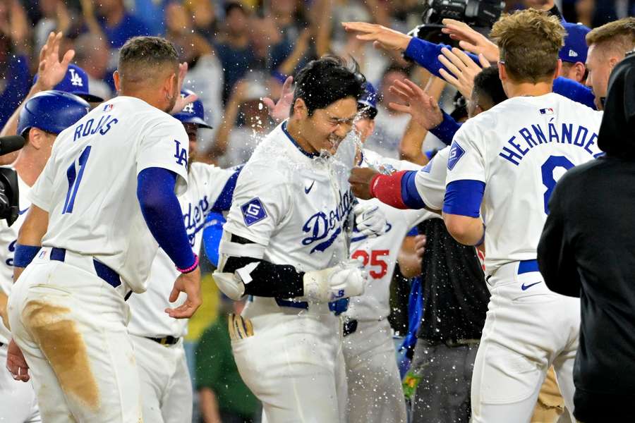 Shohei Ohtani (centre) is congratulated after hitting a grand slam walk off home run for his 40th of the season