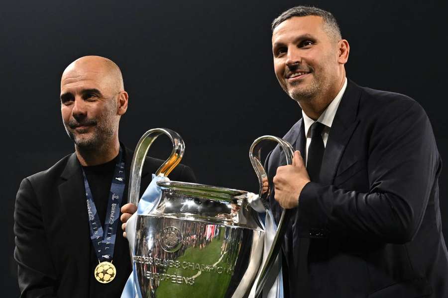 Man City manager Pep Guardiola and chairman Khaldoon al-Mubarak pose with the European Cup after winning the Champions League