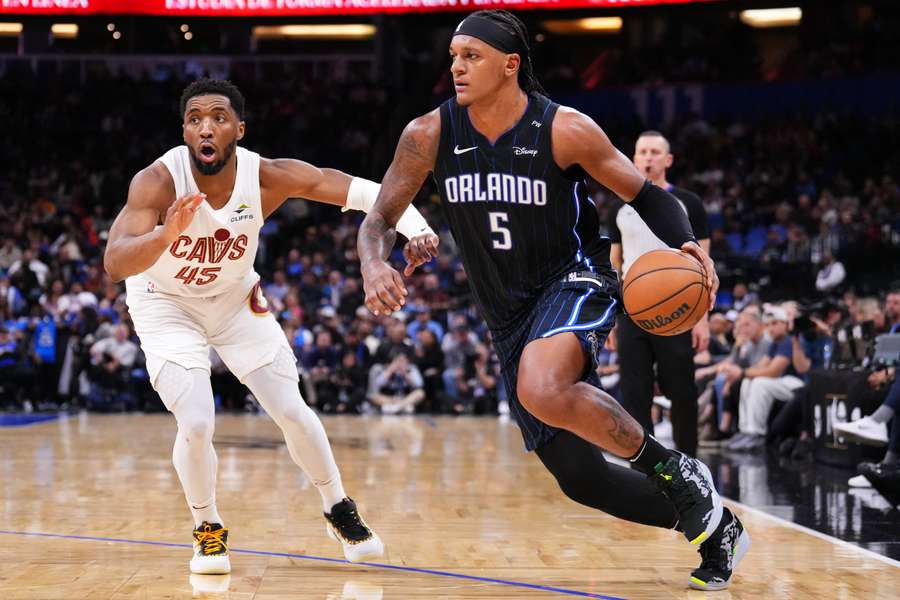 Magic forward Paolo Banchero driving past Cleveland Cavaliers guard Donovan Mitchell (2025)