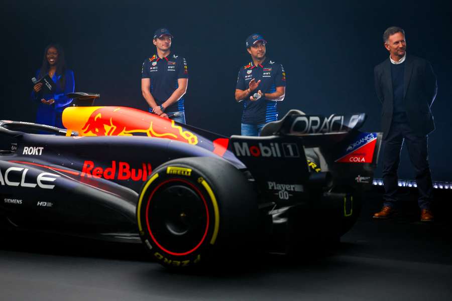 Max Verstappen, Sergio Perez and Team Principal Christian Horner stand with the RB20 