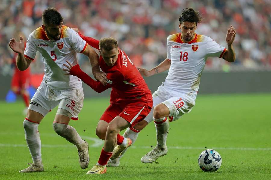 Kerem Akturkoglu tussles with Montenegro players