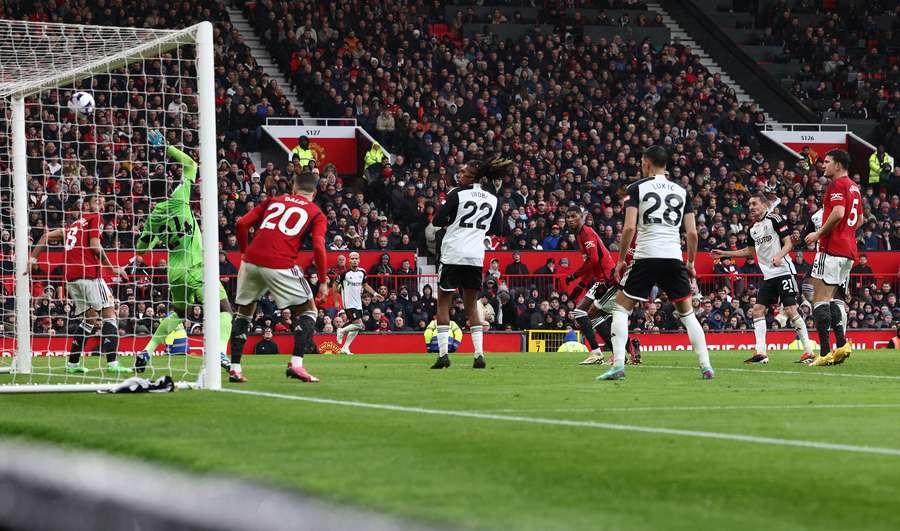 Manchester United's Cameroonian goalkeeper #24 Andre Onana (2L) concedes the opening goal from Fulham's Italian-born Nigerian defender #03 Calvin Bassey