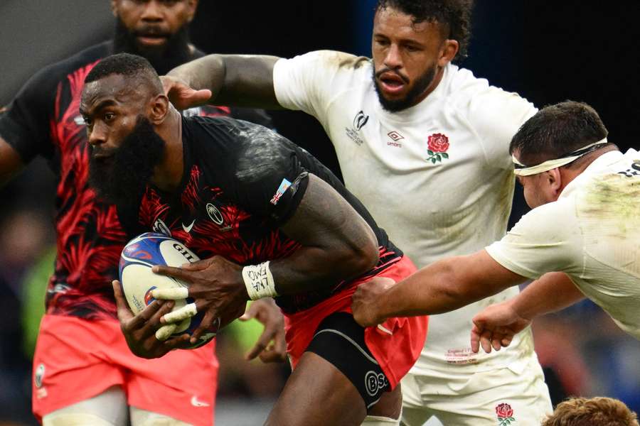 Fiji's left wing Semi Radradra runs with the ball against England during their quarter-final defeat