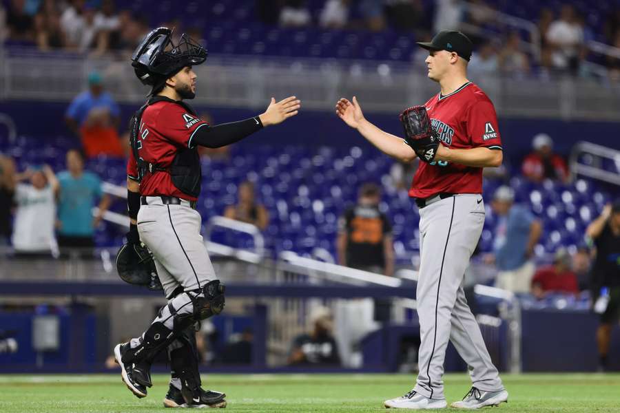 Paul Sewald (right) celebrates with catcher Adrian Del Castillo after the game against the Marlins