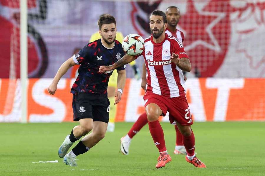 Nicolas Raskin of Rangers and Sergio Oliveira of Olympiacos battle for the ball