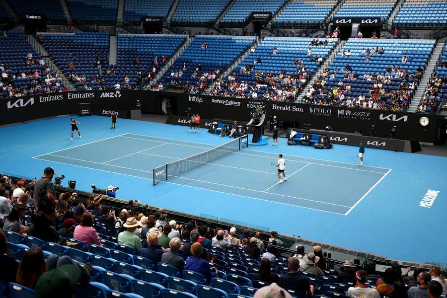 Carlos Alcaraz and Taylor Fritz train together at Rod Laver Arena on Tuesday.