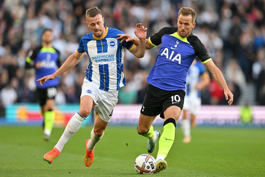 Brighton's defender Adam Webster vies with Harry Kane during the match between Brighton and Tottenham Hotspur