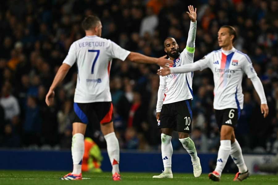 Alexandre Lacazette, centre, celebrates after scoring Lyon's third goal at Rangers