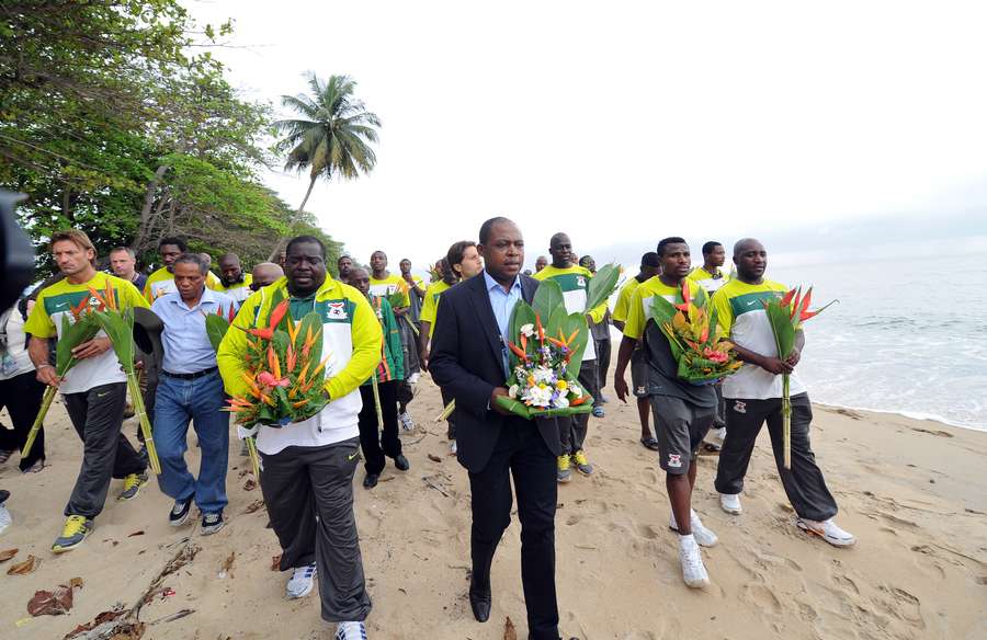 Zambia legend Kalusha Bwalya lays a wreath at the scene of the crash in Libreville along with the 2012 squad