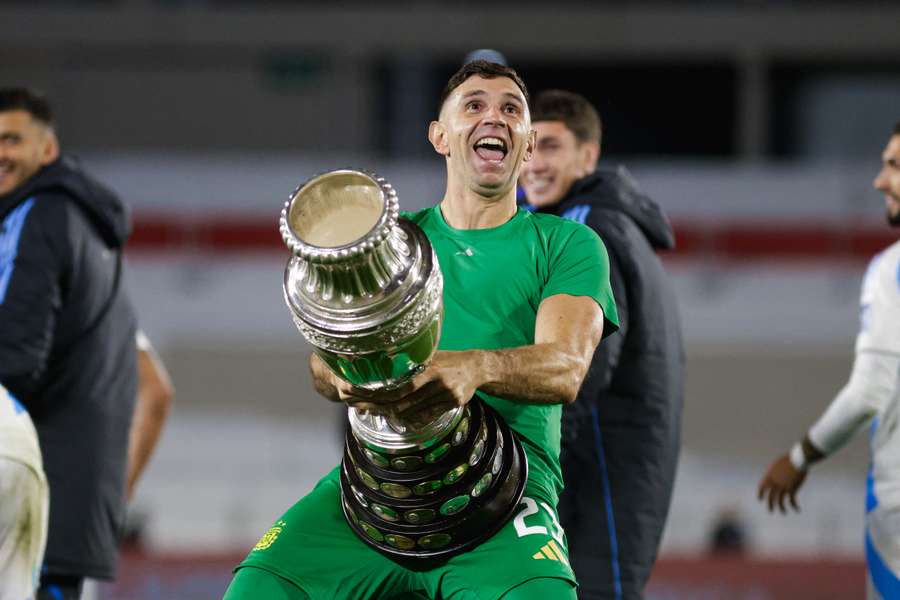 Argentina goalkeeper Emiliano Martinez celebrates with the Copa America trophy