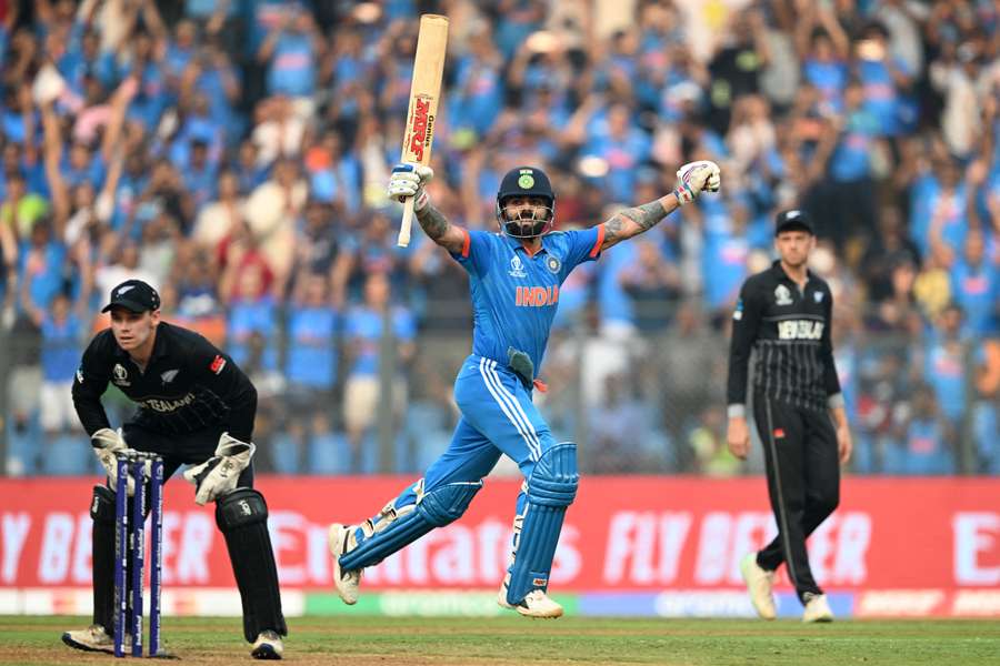 India's Virat Kohli celebrates after scoring his record-breaking century against New Zealand