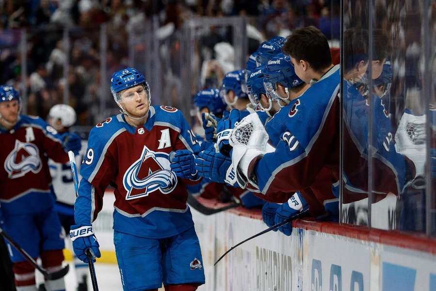 Colorado Avalanche centre Nathan MacKinnon celebrates with the bench after his goal in the third period against the Winnipeg Jets