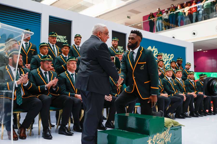 South Africa flanker Siya Kolisi greets Mark Alexander, South African Rugby Union president, during their World Cup squad announcement