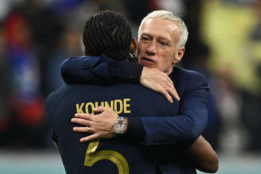 Didier Deschamps hugs Jules Kounde as his team beat England to reach the World Cup semi-finals.