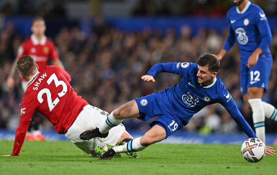 Mason Mount and Luke Shaw tussle for the ball