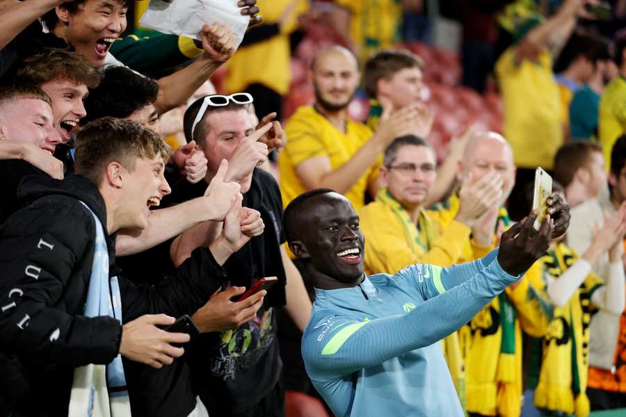 Awer Mabil celebrated with fans after the match